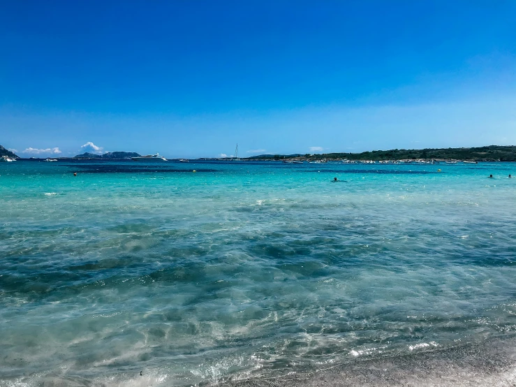 the clear water of the ocean with the boat in the distance