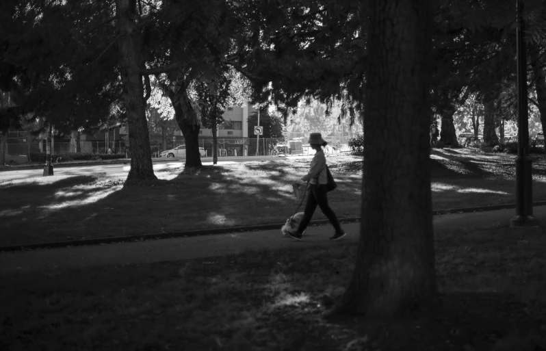 a girl walking on a path holding a ball