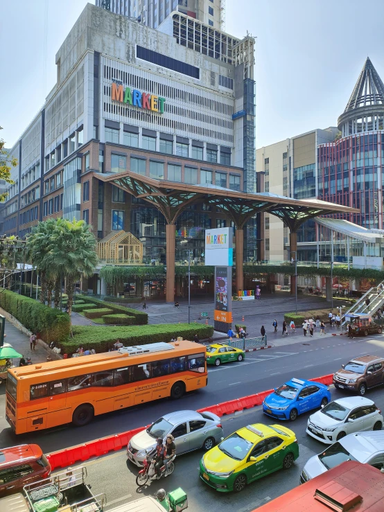 a busy city street with traffic and people crossing it