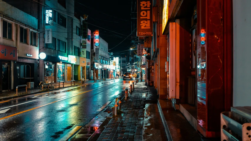 a street at night with some shops and other buildings