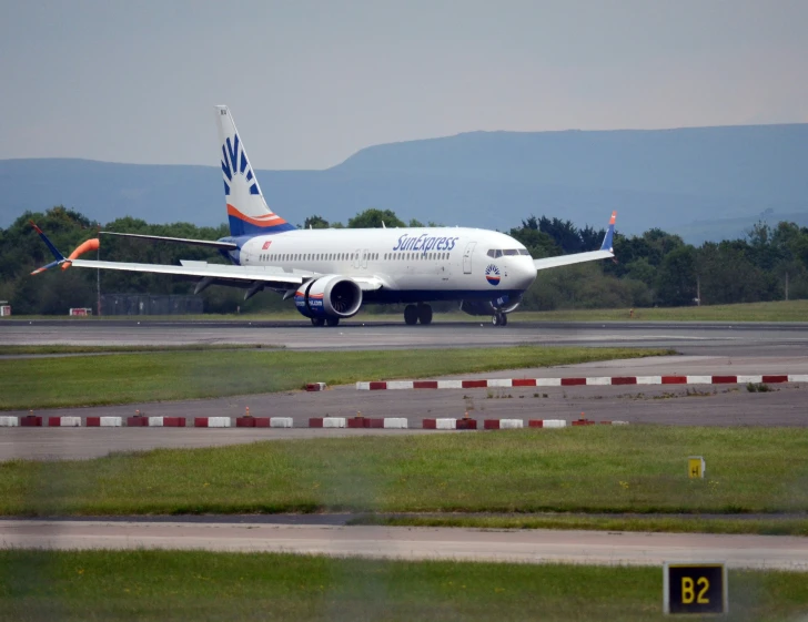 a white airplane is sitting on the runway