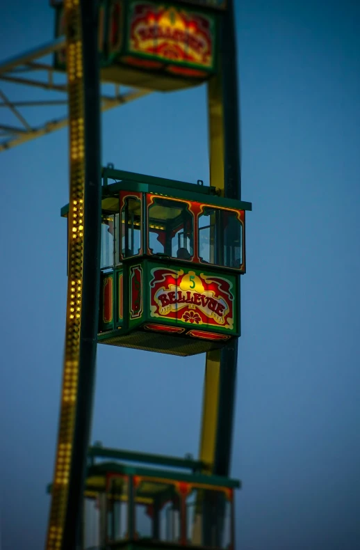 a ferris wheel spinning in the air during dusk