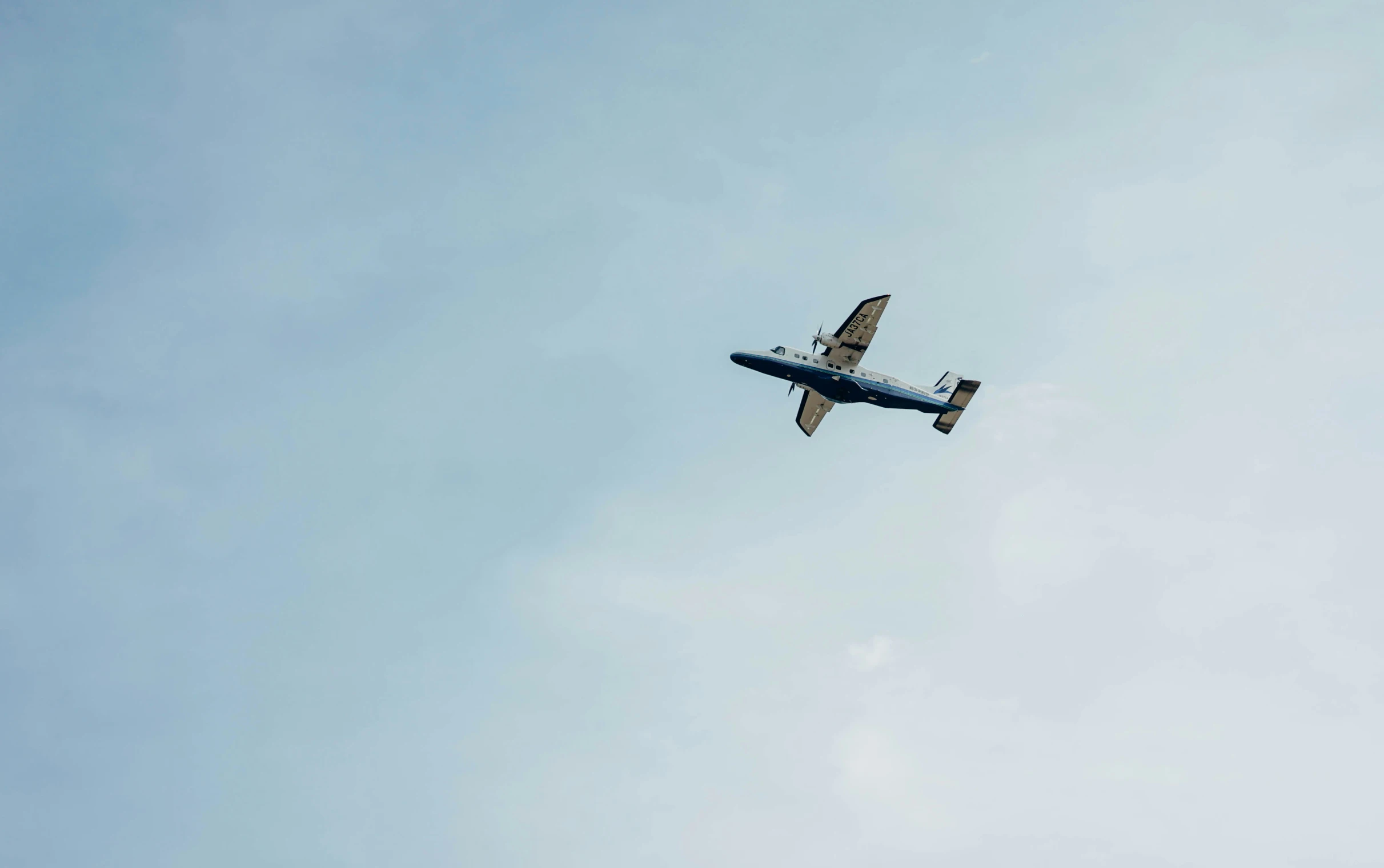 an airplane flying through the clear blue sky