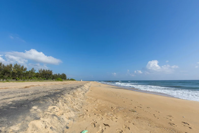 a sandy beach on the edge of the water