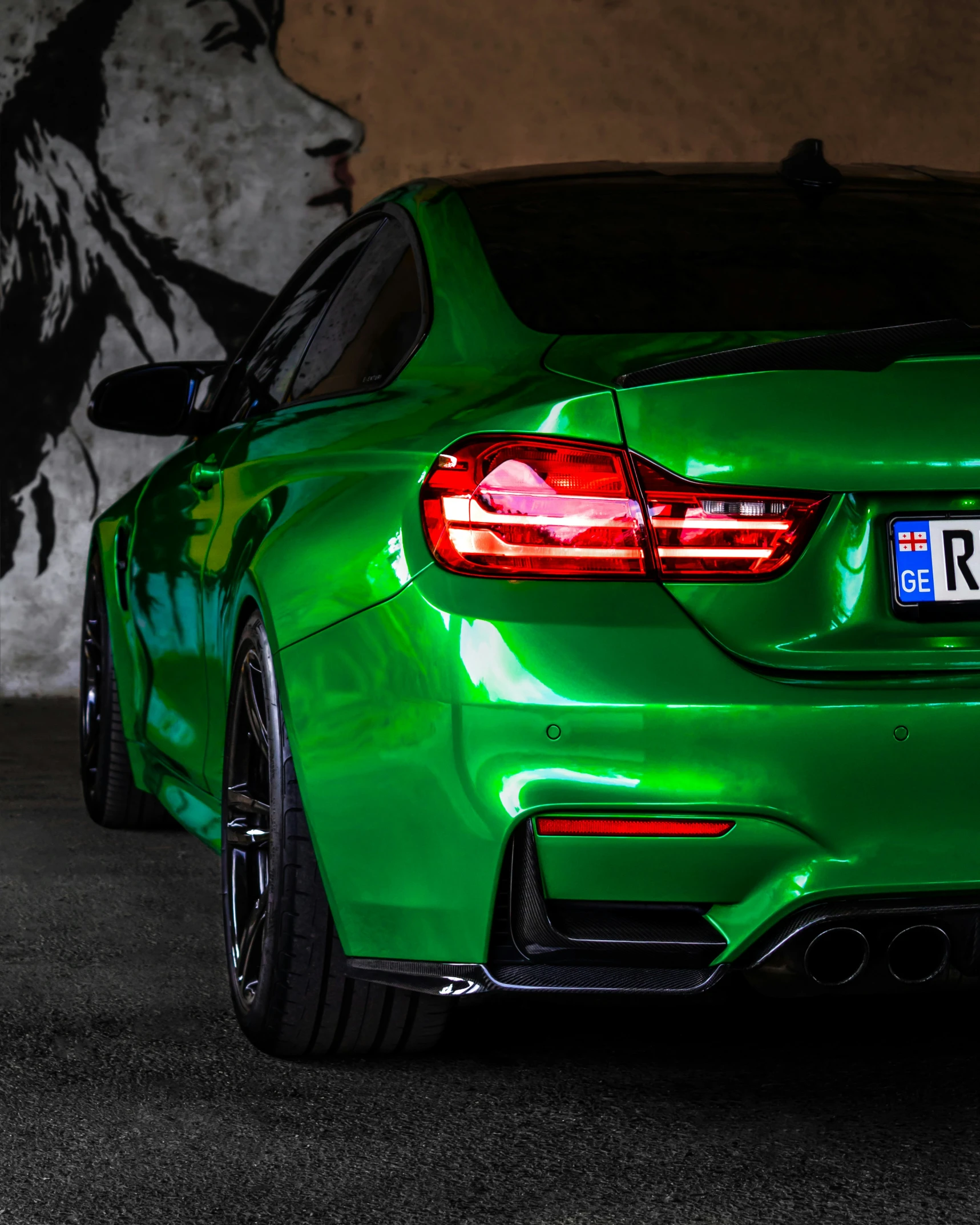 an all green bmw sedan with chrome wheels