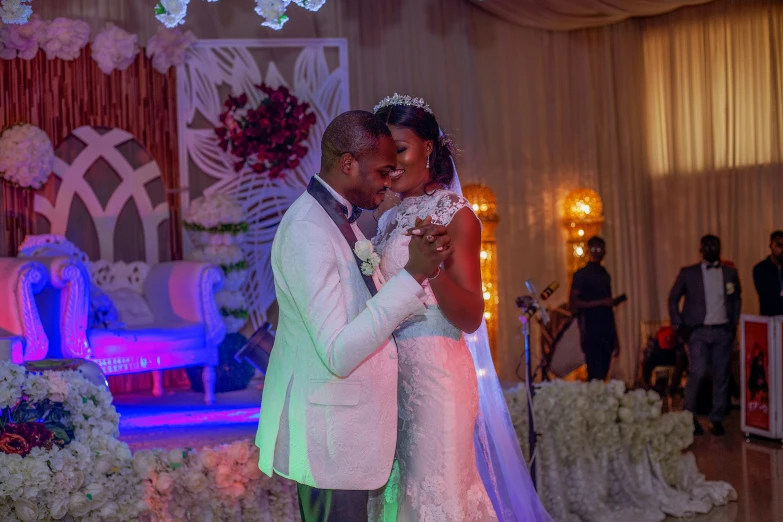 a newlywed couple standing together during their wedding reception