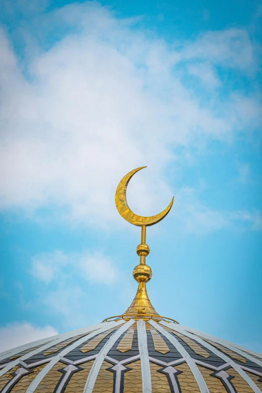 an oriental style building has a crescent shaped metal decoration on top