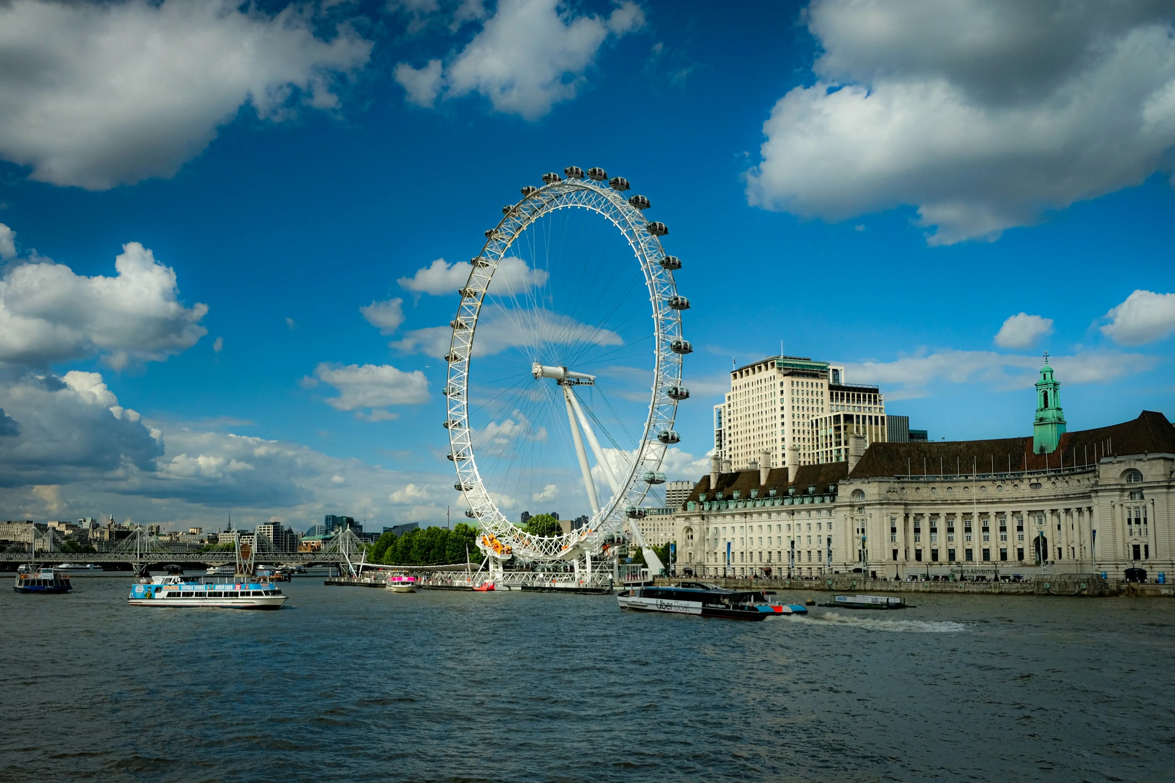 a large building with a big giant wheel in the background