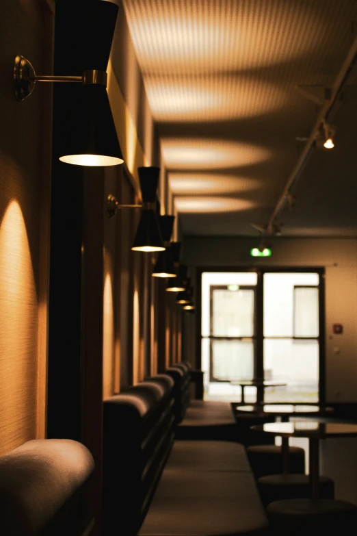 a dimly lit hallway with several tables and chairs