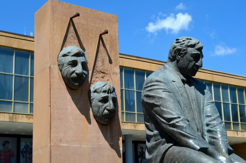 statue of president aham lincoln and another sculpture of president aham lincoln outside a building