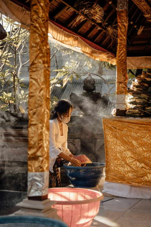 a woman cooking food outside at a restaurant