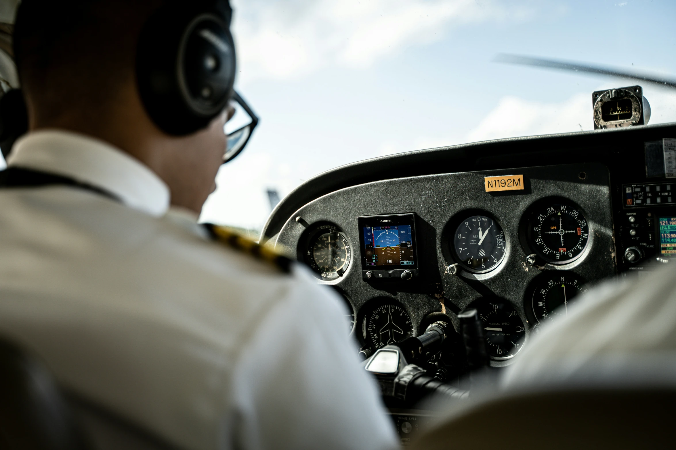 a man in headphones in a small airplane