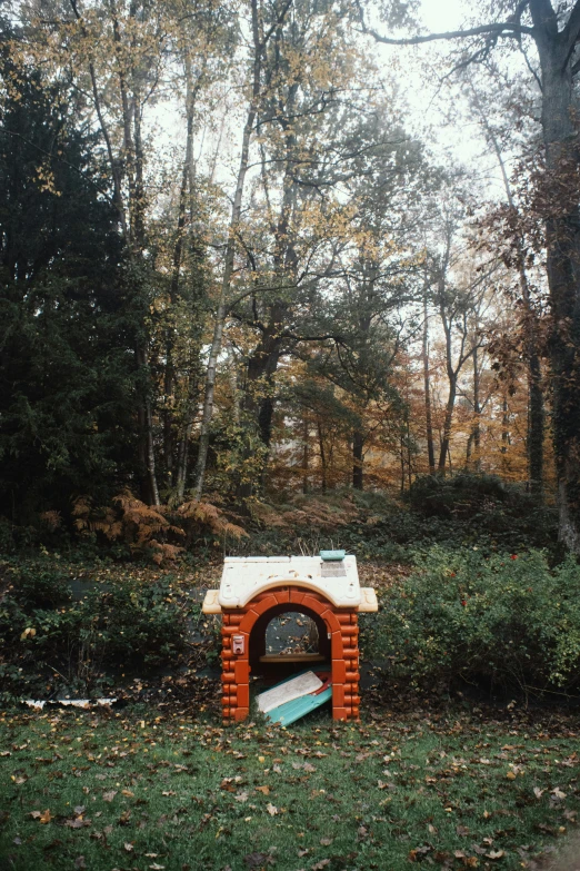 a fake fireplace with a wooden roof in a park