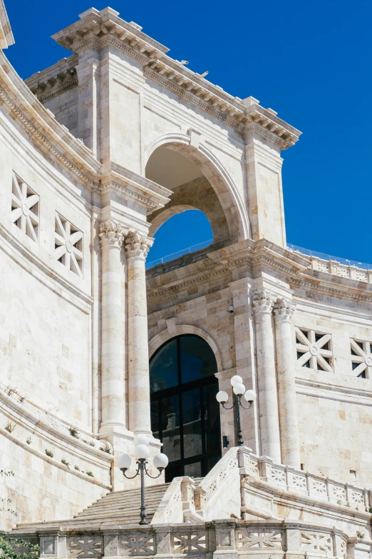 a white, ancient building with white and grey columns