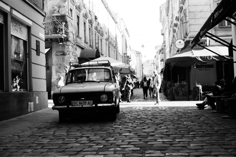 a van on the street between a group of people