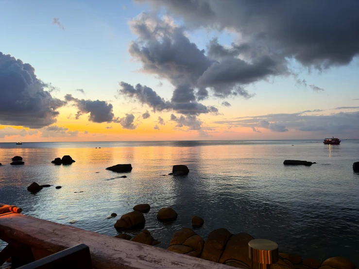 several rocks and sea in the ocean at dusk