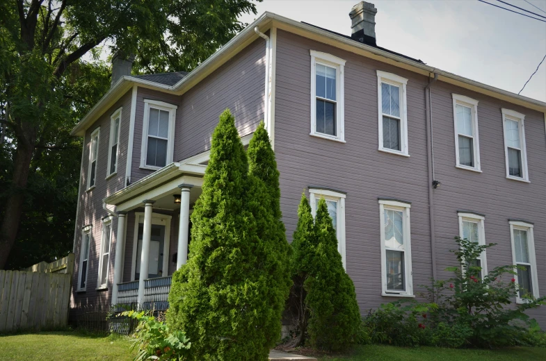 a two story house with white trim and windows