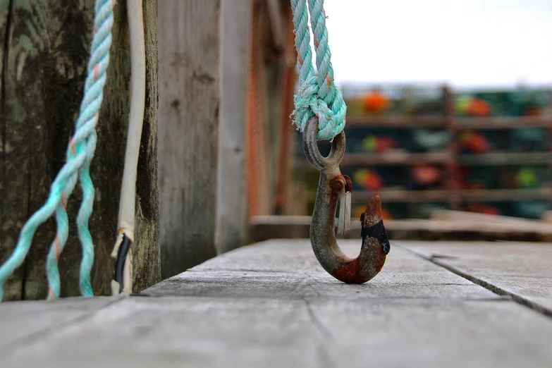 a brown and green hook with a blue string