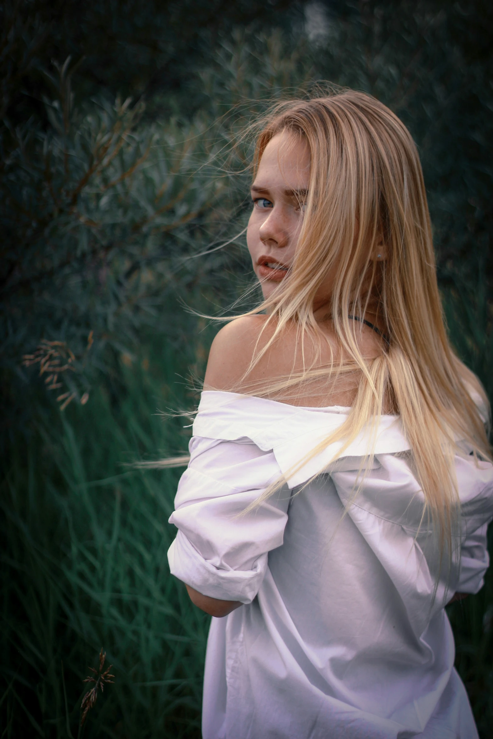 a young blonde woman posing with a feathered headband