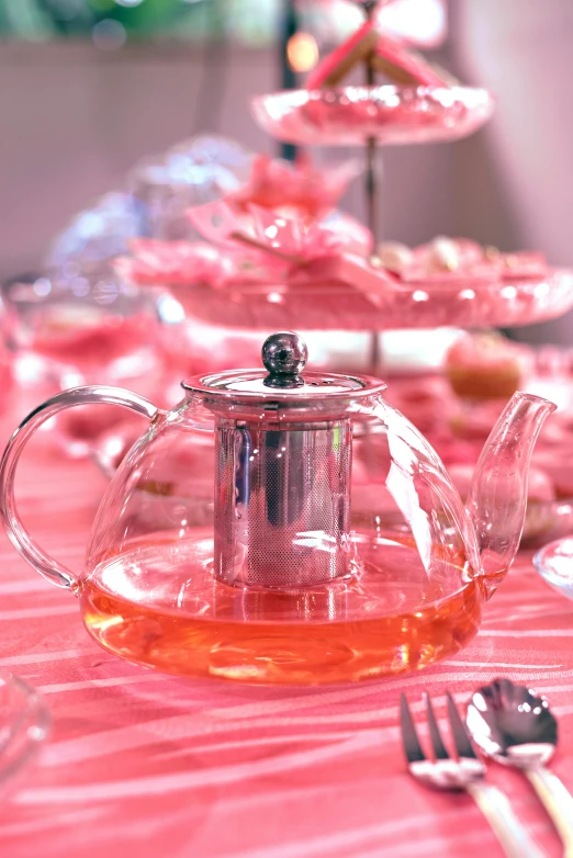 an empty tea kettle sits next to a tray with other plates and utensils on it