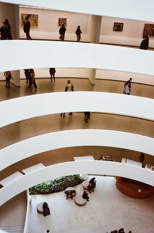 people are walking through a building while others walk around it