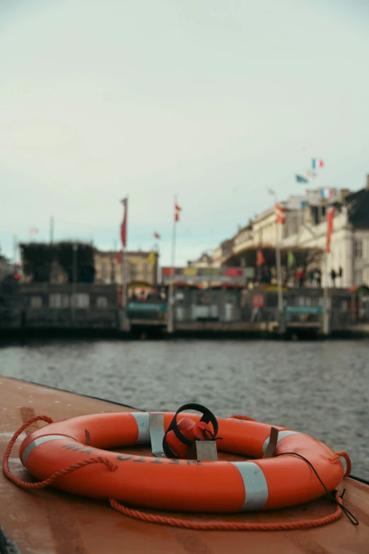 the orange life preserver has been placed next to the water