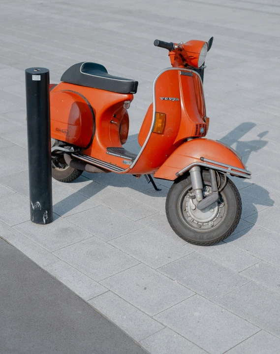 a scooter sits outside next to the street