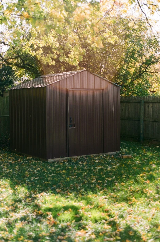 a shed sitting on top of a lush green field