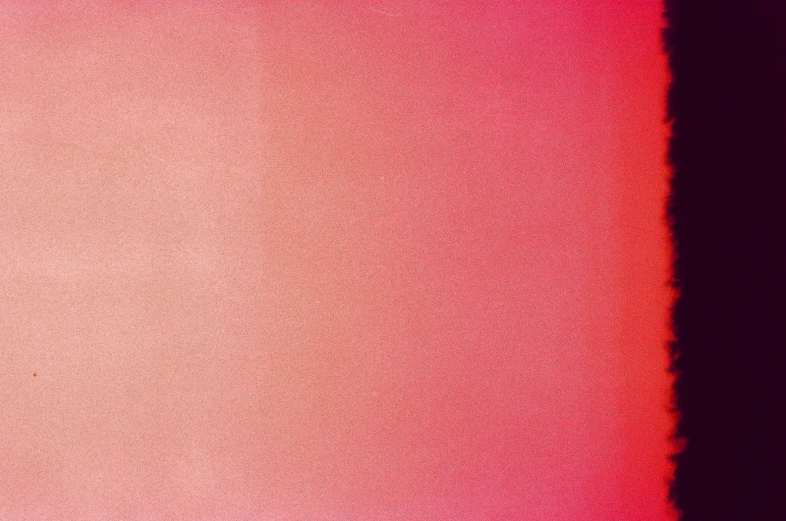 the bottom of a wall that is red, purple and pink