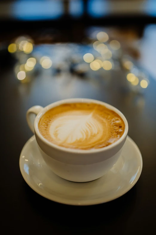 a cup of latte art on a saucer