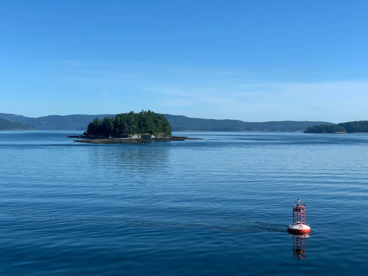 a small island and some small boats in the water