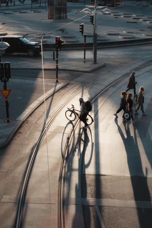 people on bikes riding along the sidewalk in the city