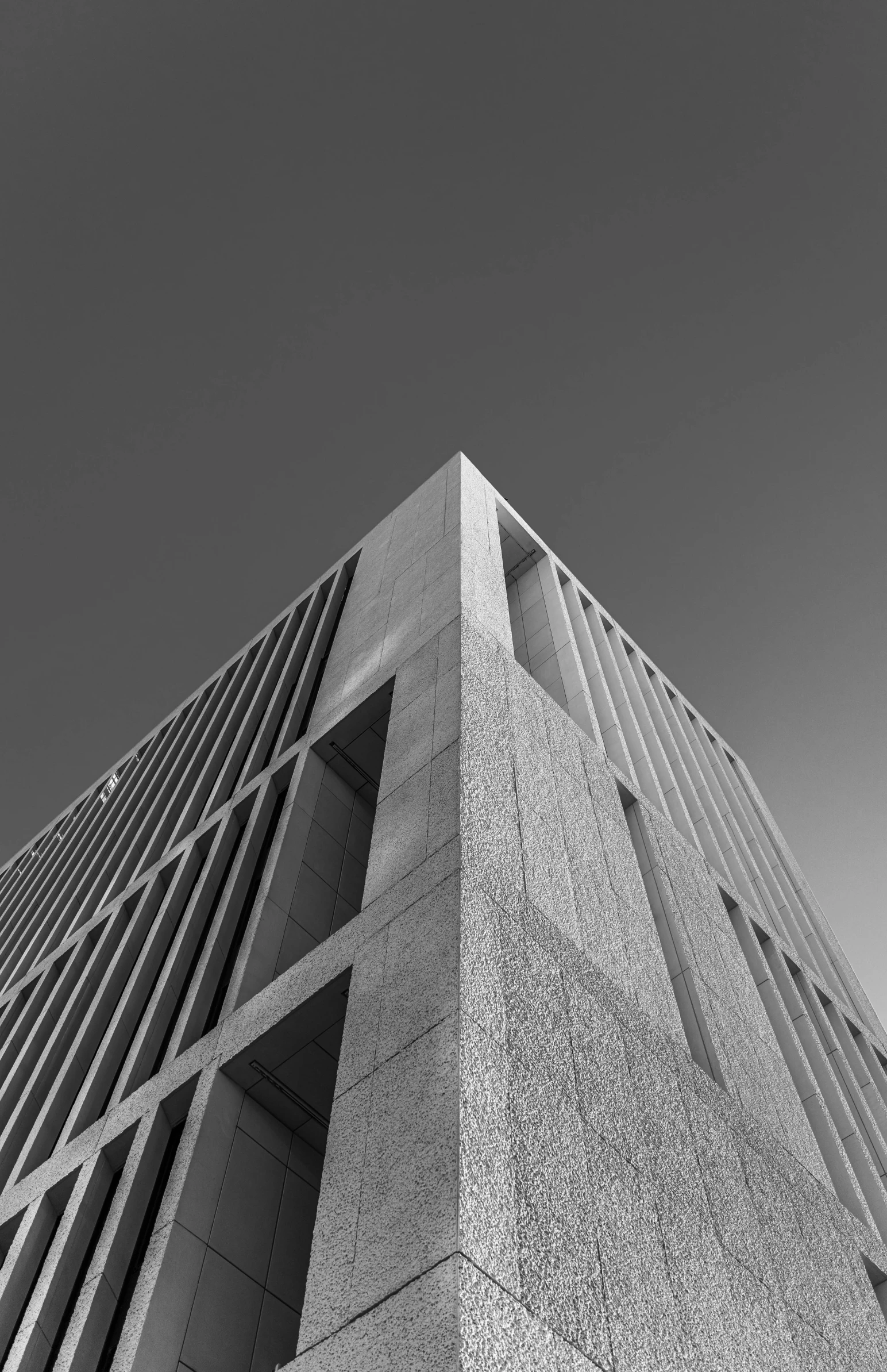 a large grey building next to a sky