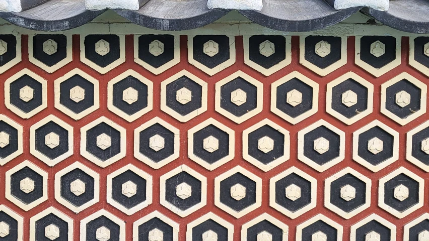 the roof in front of the building has red and black pattern