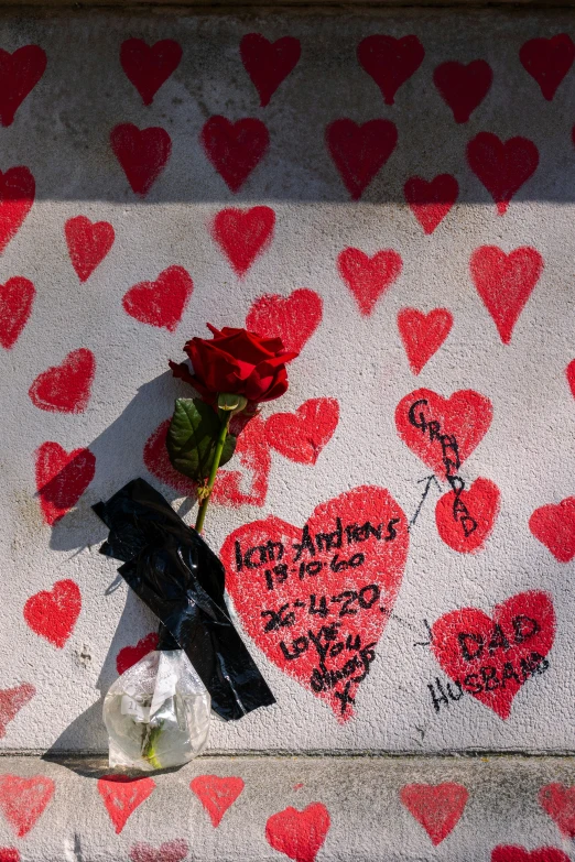 graffiti on the sidewalk with a rose and another on it