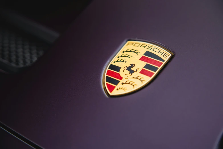 a close up of the hood badge on a purple car