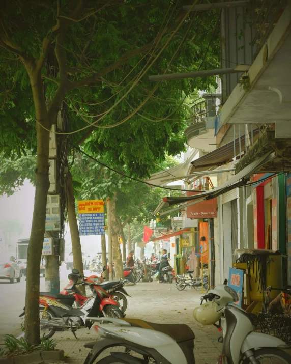 motorcycles parked on a side walk next to the street