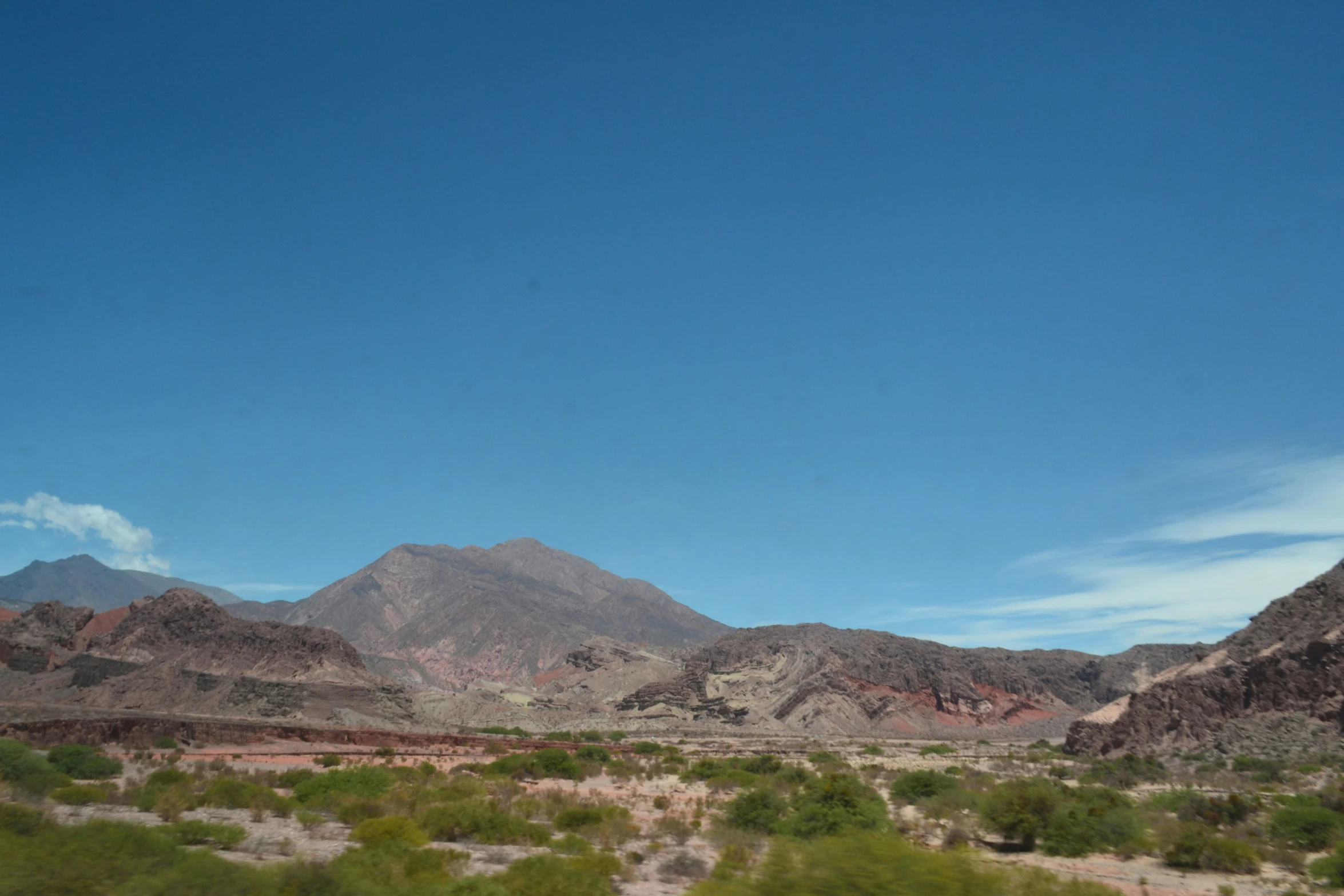 a view of the mountains and desert like terrain