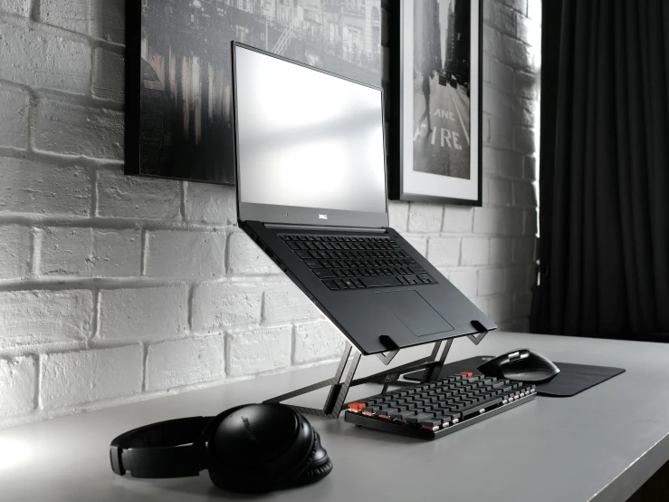 a computer and headphones sitting on top of a desk