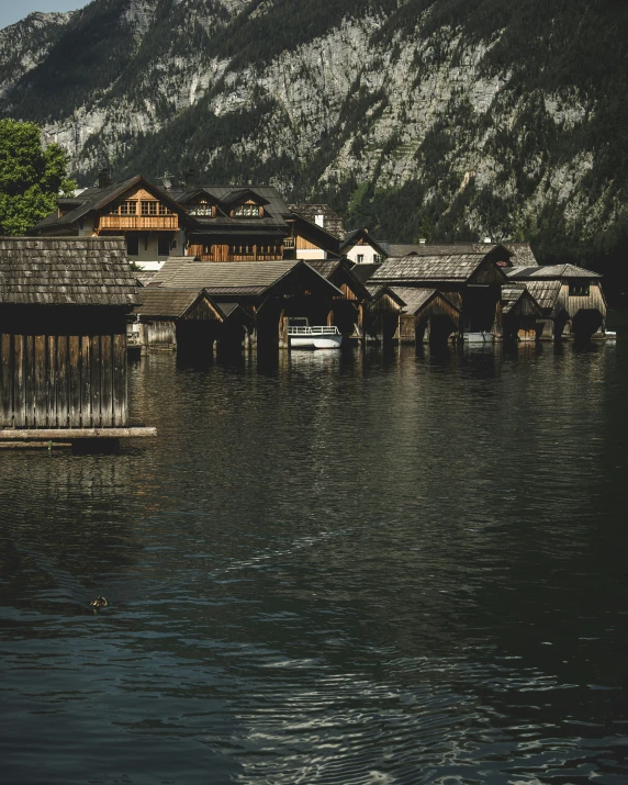 a house on the water near a mountain range