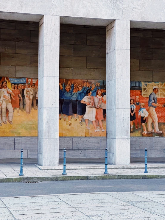 four pillars hold a display of images on concrete walls