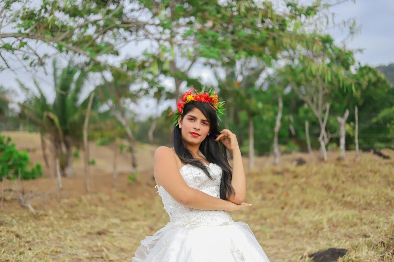 the woman in the dress is posing on the grass