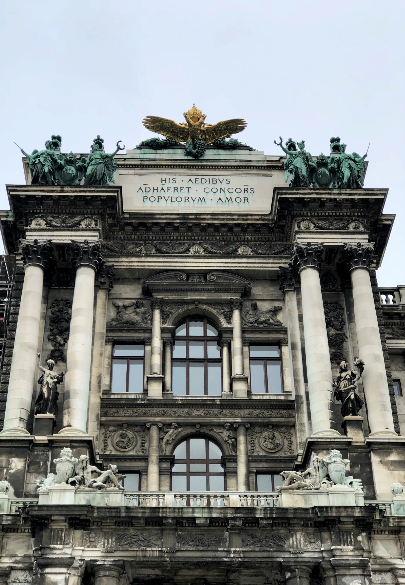 a stone building with a gold double headed eagle on top