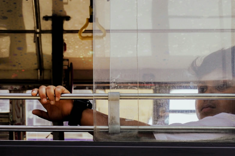 a man staring out the window from inside a building