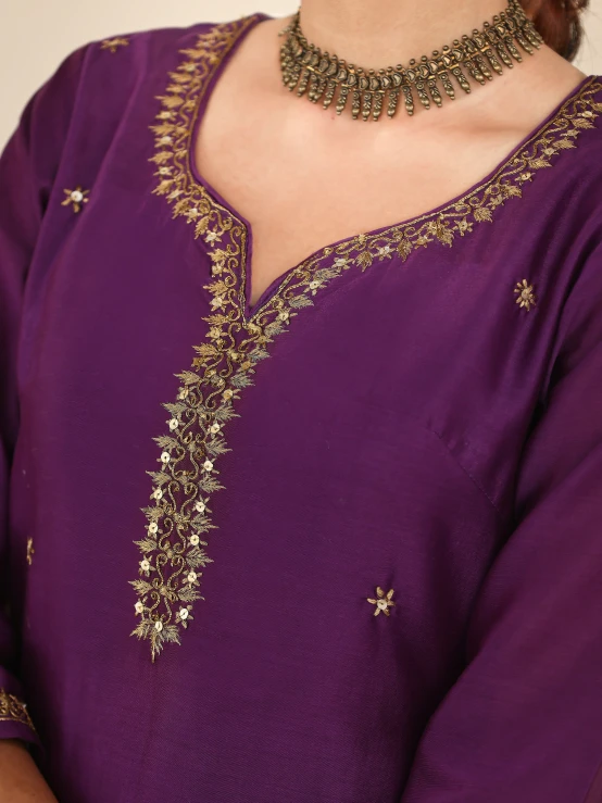 a woman wearing an elegant purple outfit