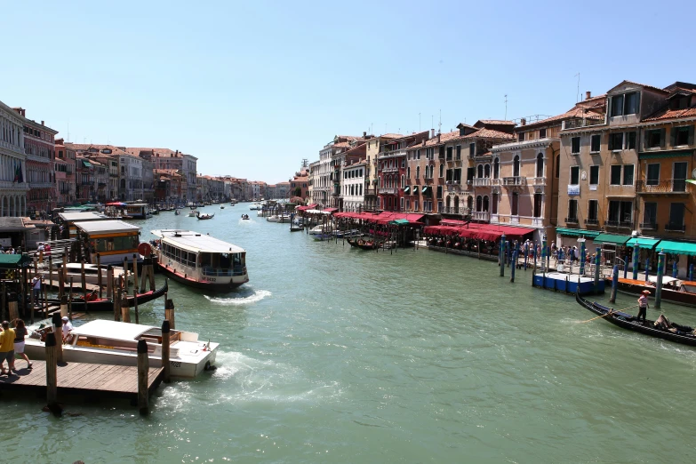 a canal running between some buildings and some water