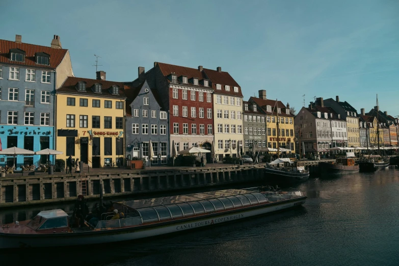 many different colored buildings sit along the water