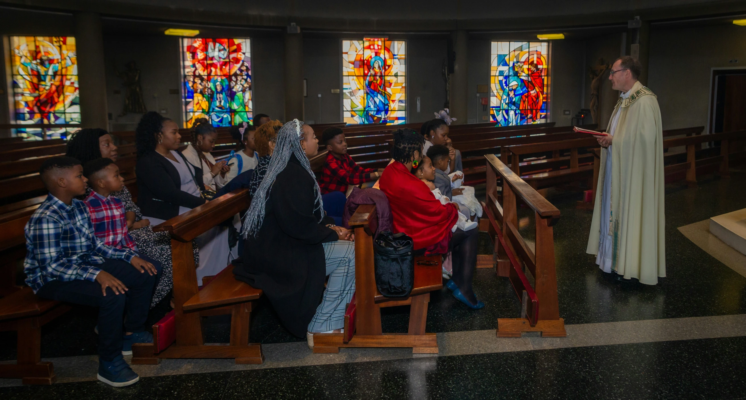 a woman in a church talks to a group of people