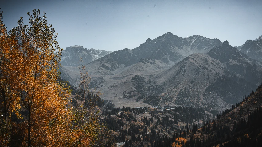 the snow covered mountains are shown from the valley