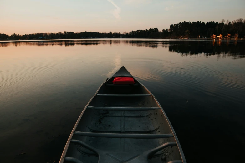 the canoe is moving down the water in the evening